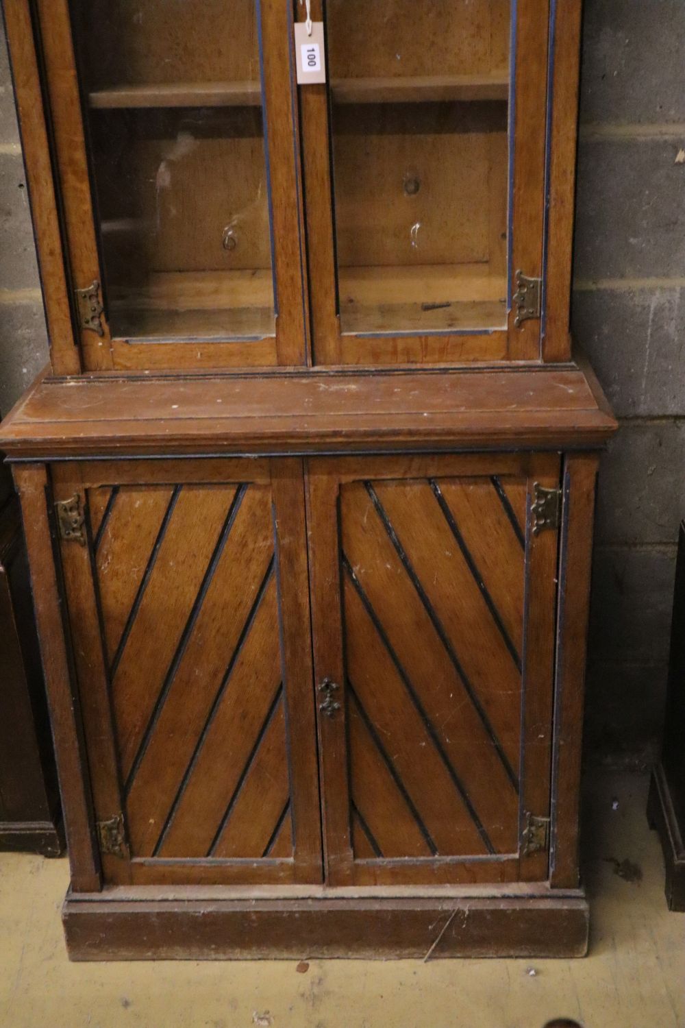 A late Victorian oak aesthetic movement bookcase cupboard, width 79cm depth 45cm height 216cm
